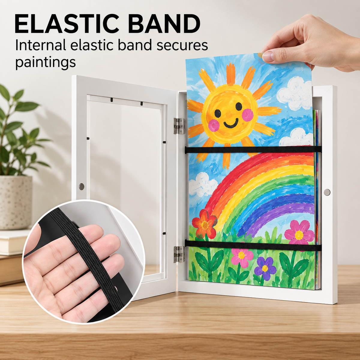 Open white MyPicasso art frame showing the internal elastic band that holds a child's rainbow painting in place